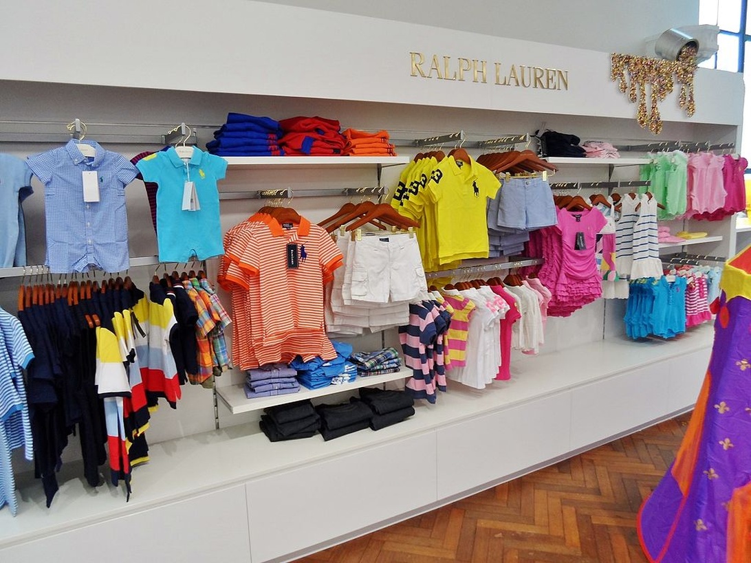 Twee kinderen, een jongen en een meisje, dragen stijlvolle outfits van Polo Ralph Lauren.